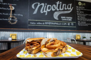 SLICE AND P'UNK BURGER OWNERS MARLO AND JASON DILKS ANNOUNCE THE GRAND OPENING OF NIPOTINA HAND-CRAFTED SANDWICHES